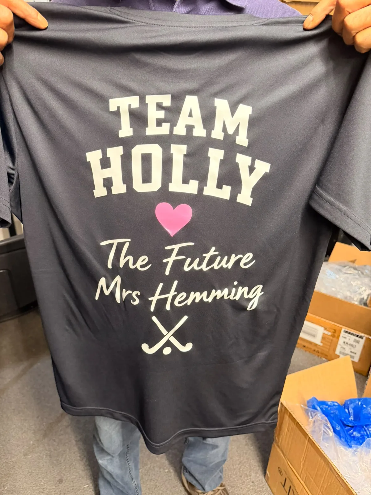 Navy performance T-shirt with a white and pink hen party back print: Team Holly, The Future Mrs Hemming