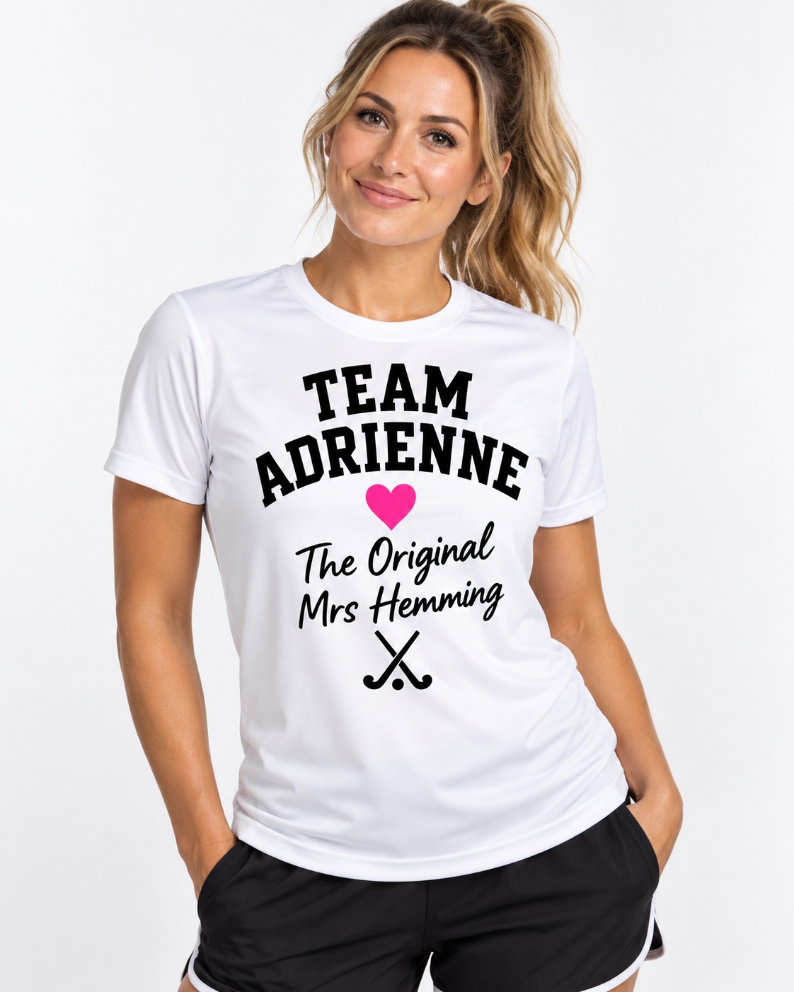 White performance sports T-shirt worn by a woman, printed with a pink heart and Team Adrienne hen party design